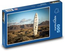 Deska surfingowa utknęła w ziemi Puzzle 500 elementów - 46x30 cm