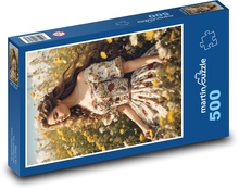 A woman sitting on a meadow in flowers Puzzle of 500 pieces - 46 x 30 cm 