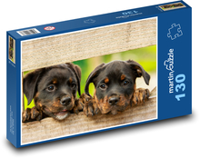 Rottweiler puppies peeping out of the fence Puzzle 130 pieces - 28.7 x 20 cm 